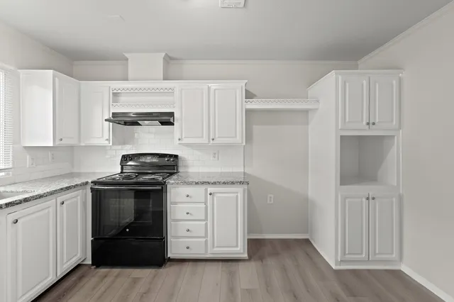 a kitchen with stainless steel appliances granite countertop a stove and a refrigerator