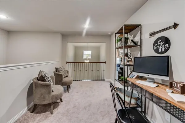 a view of a workspace with furniture and a gate