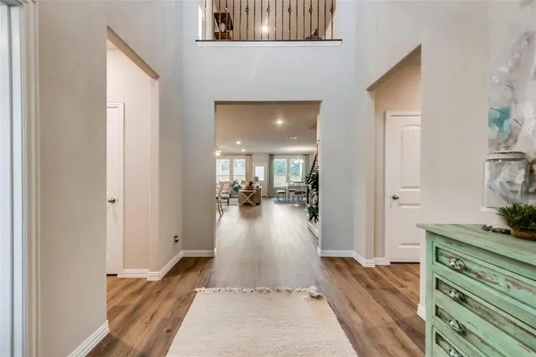 a view of a hallway view with wooden floor and living room