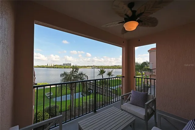 a view of a chair and tables in the balcony