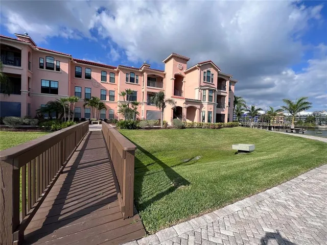 a view of a big building with a big yard and large trees