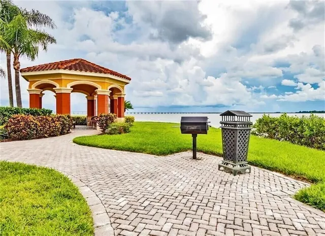 a front view of a house with a yard and potted plants