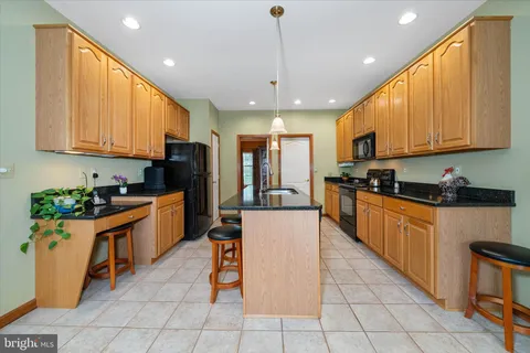 a kitchen with stainless steel appliances granite countertop a stove sink and cabinets