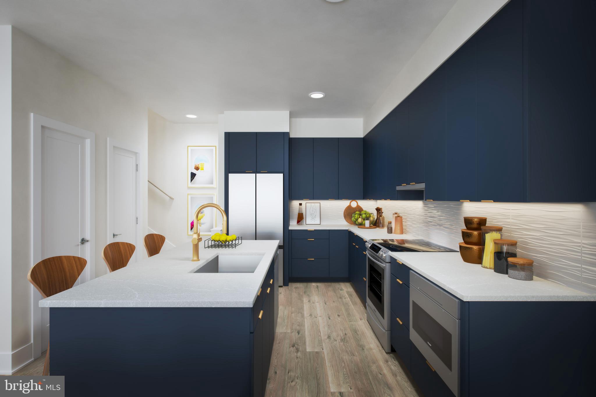 61 Lower Service Road Northwest, Unit POWELL 820 Washington, DC 20422 - Photo 4 of 12 a kitchen with stainless steel appliances a sink a stove top oven a counter space and cabinets