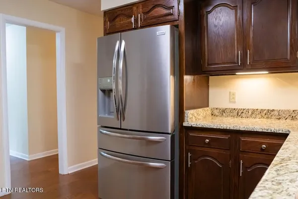 a kitchen with metallic refrigerator and cabinets