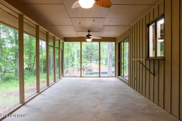 a view of an empty room with a floor to ceiling window