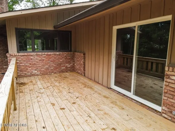 a view of an empty room with a fireplace and a window