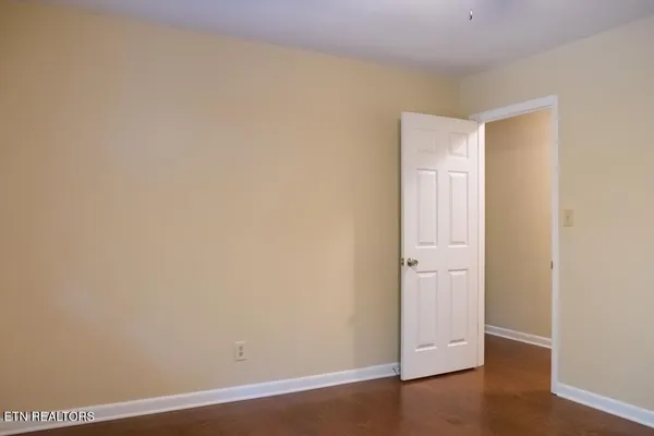 a bathroom with a granite countertop sink and a toilet