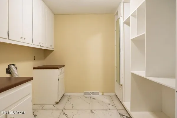 a living room with a fireplace and a floor to ceiling window