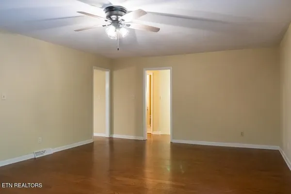 a view of room with hardwood floor and ceiling fan