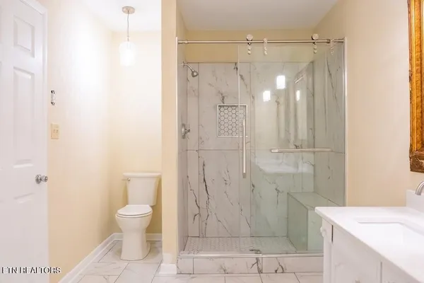 a view of a kitchen with a sink and refrigerator