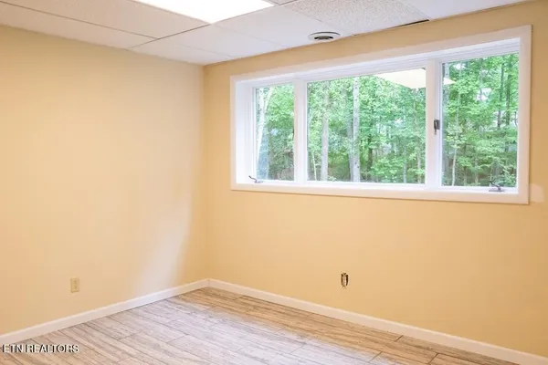 a view of a small space with wooden floor and a window