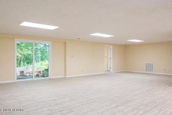 an aerial view of residential houses with outdoor space and trees