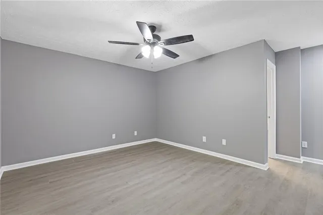 a view of an empty room with wooden floor