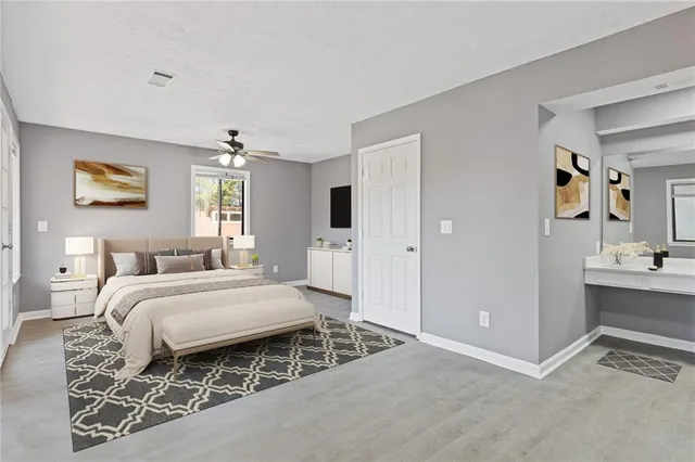 a spacious bedroom with a bed and window