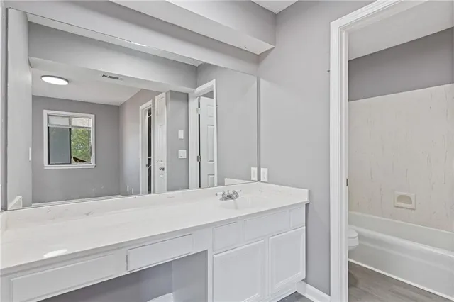 a bathroom with a sink a mirror and a bathtub