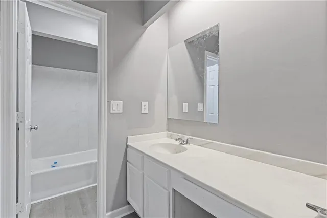 a bathroom with a sink a shower and a mirror