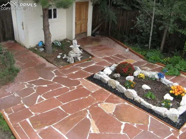 a garden with lots of plants and seating space