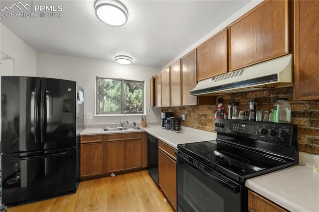 a kitchen with a sink appliances and cabinets
