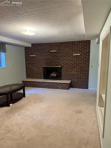 a view of an empty room with a fireplace