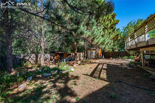 a view of backyard with swimming pool and sitting area