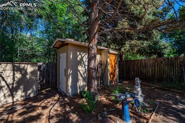 a backyard of a house with barbeque oven and outdoor seating