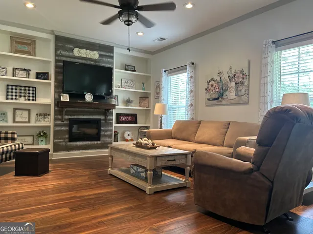 a living room with furniture a flat screen tv and a fireplace
