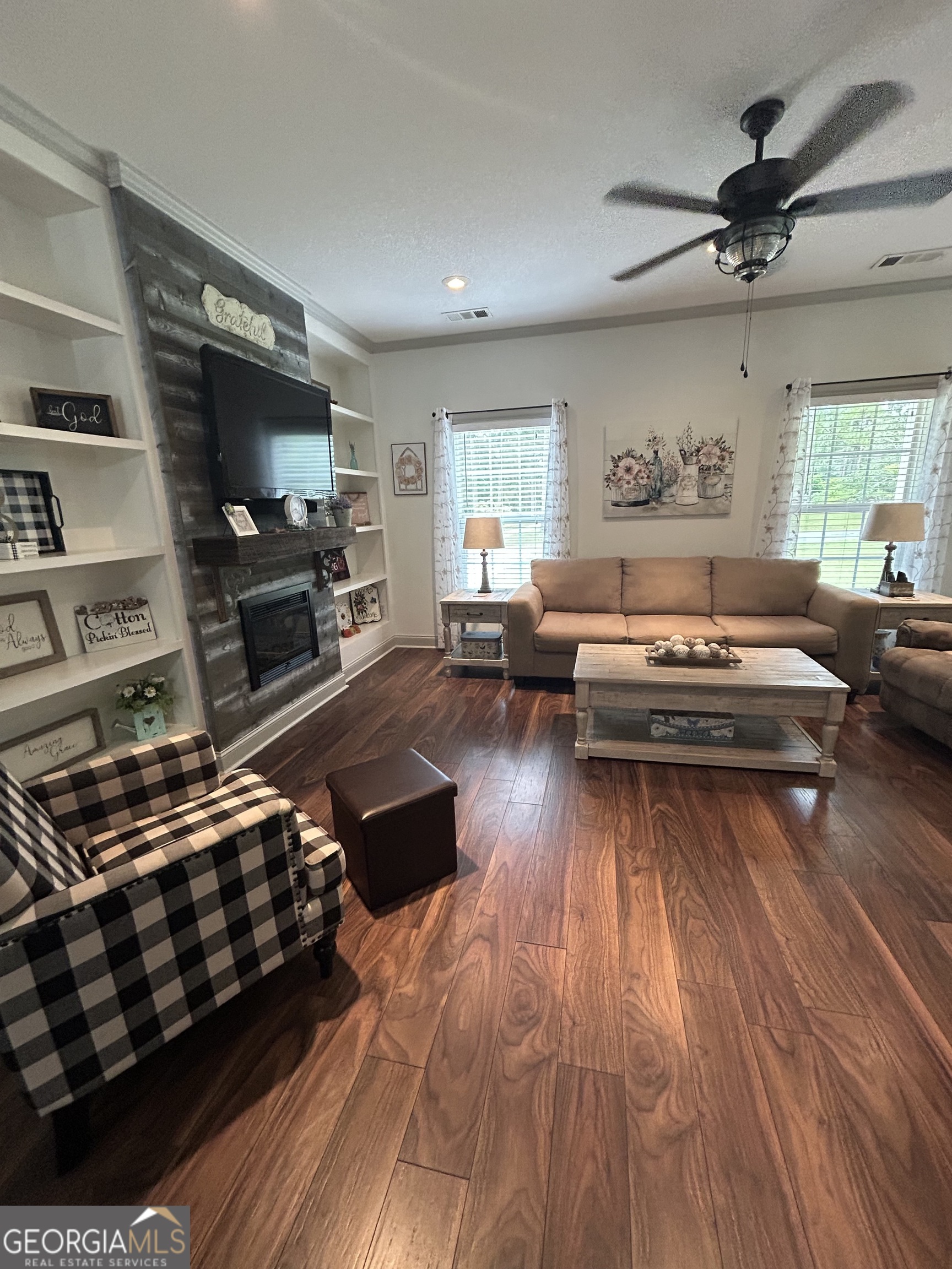 94 24th Avenue Eastman, GA 31023 - Photo 13 of 27 a living room with furniture a flat screen tv and a wooden floor