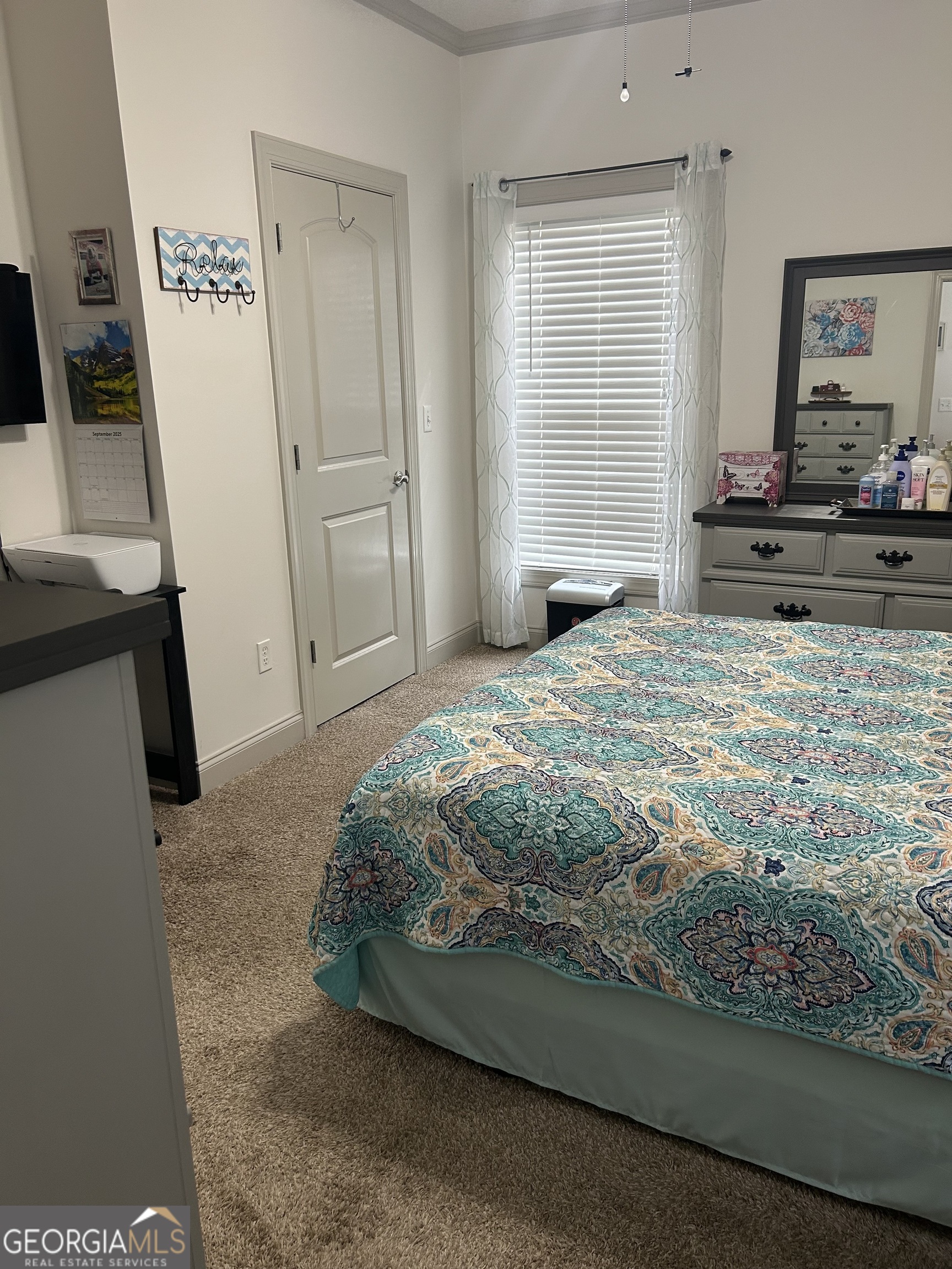 94 24th Avenue Eastman, GA 31023 - Photo 18 of 27 a bedroom with a bed and a flat tv screen on the dresser