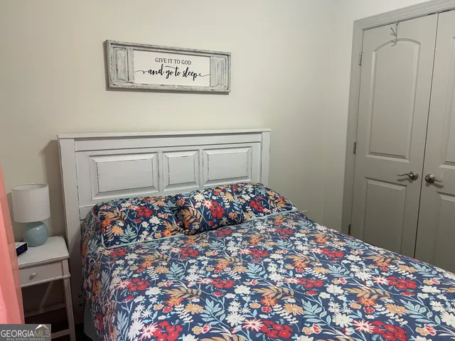 a bed room with a bed and a chair