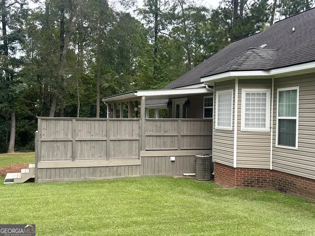 a view of a house with a large window and a yard