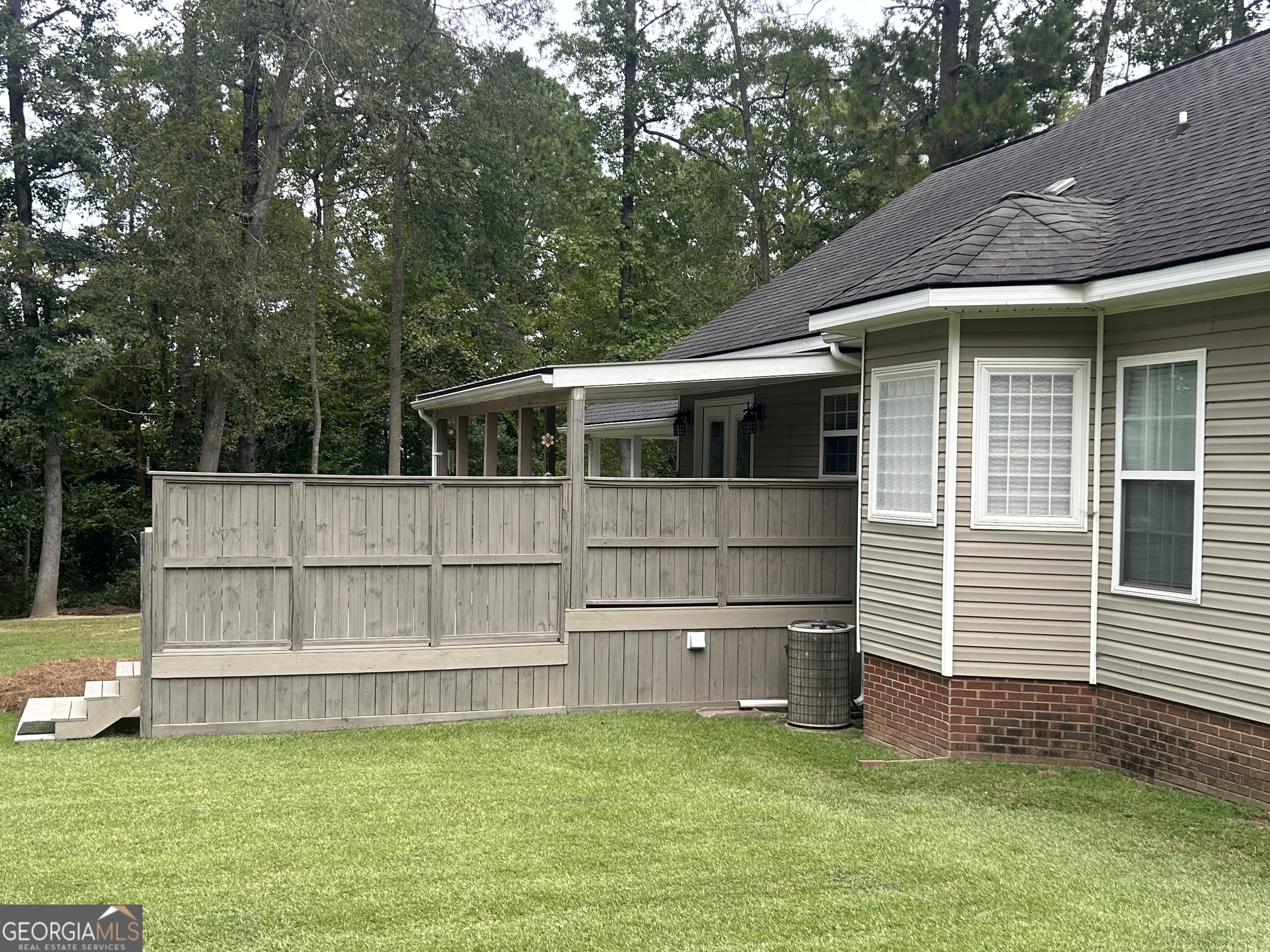 94 24th Avenue Eastman, GA 31023 - Photo 4 of 27 a view of a house with a large window and a yard