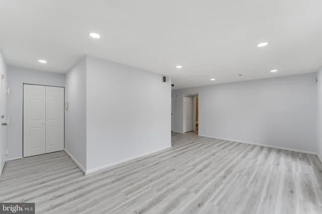 a view of an empty room with wooden floor