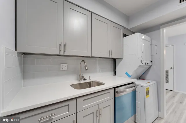 a kitchen with a sink and cabinets