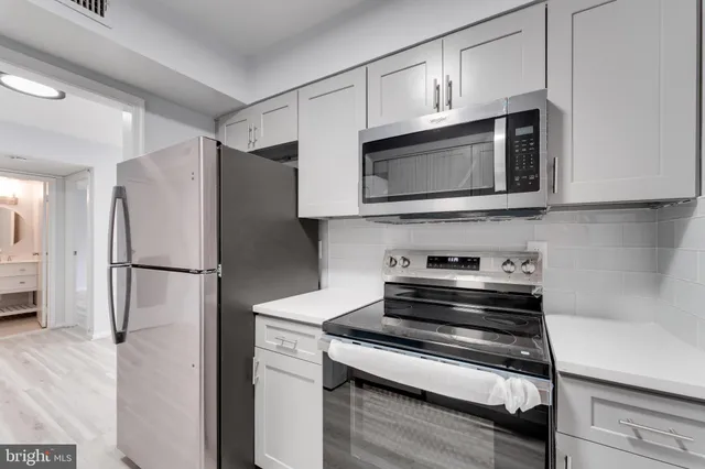 a kitchen with granite countertop cabinets and steel stainless steel appliances