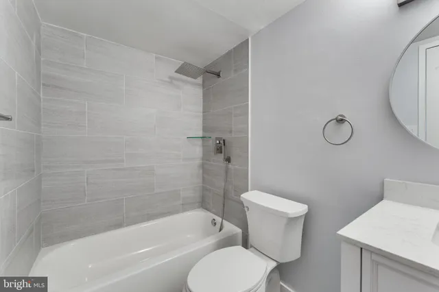 a bathroom with a toilet and a bathtub