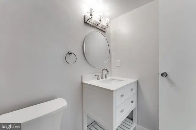a bathroom with a toilet sink and mirror