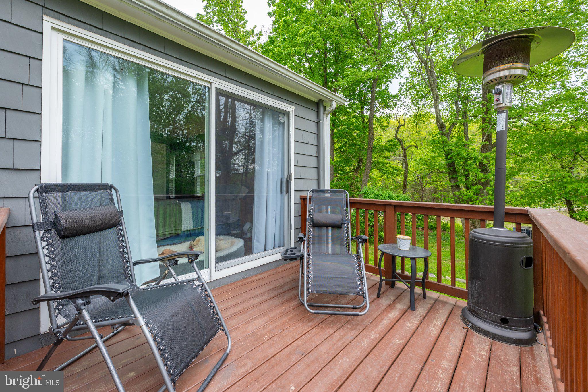 1 W Road Boonton, NJ 07005 - Photo 13 of 45 Serene deck retreat in lush greenery.