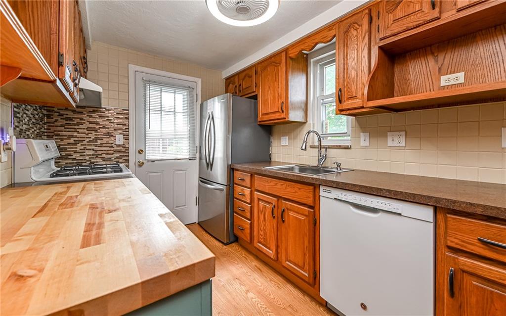 2349 Rose Garden Road Pittsburgh, PA 15220 - Photo 7 of 22 Efficient galley-style kitchen designed to maximize space and functionality.