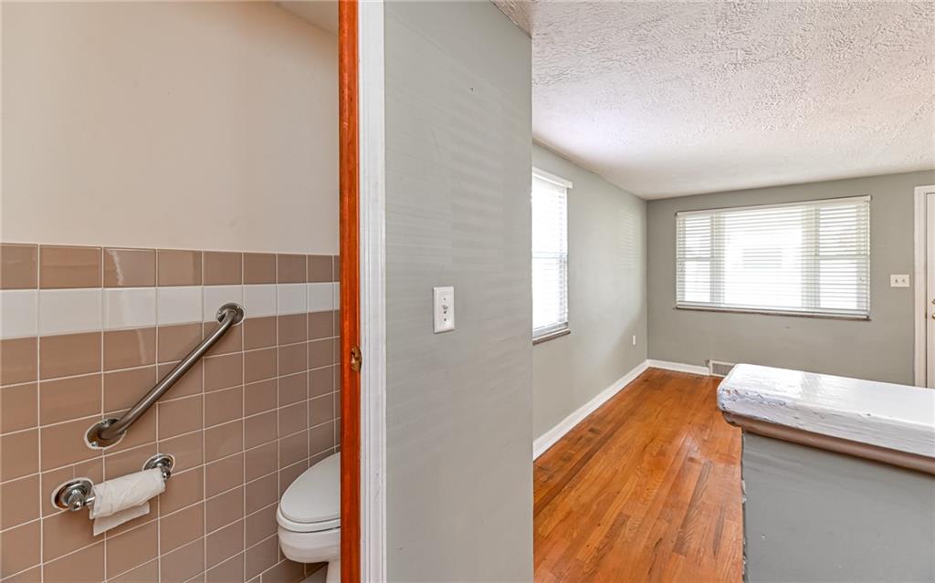 2349 Rose Garden Road Pittsburgh, PA 15220 - Photo 10 of 22 Main level coat closet has been converted into a bathroom with commode. Plumbing is under the corner of the closet with easy access to install a sink.