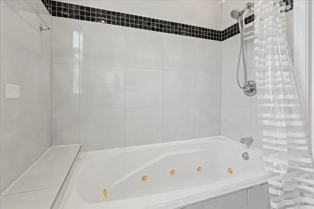 a bathroom with a bathtub and a shower