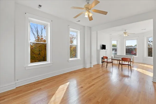 a view of a livingroom with furniture window and wooden floor