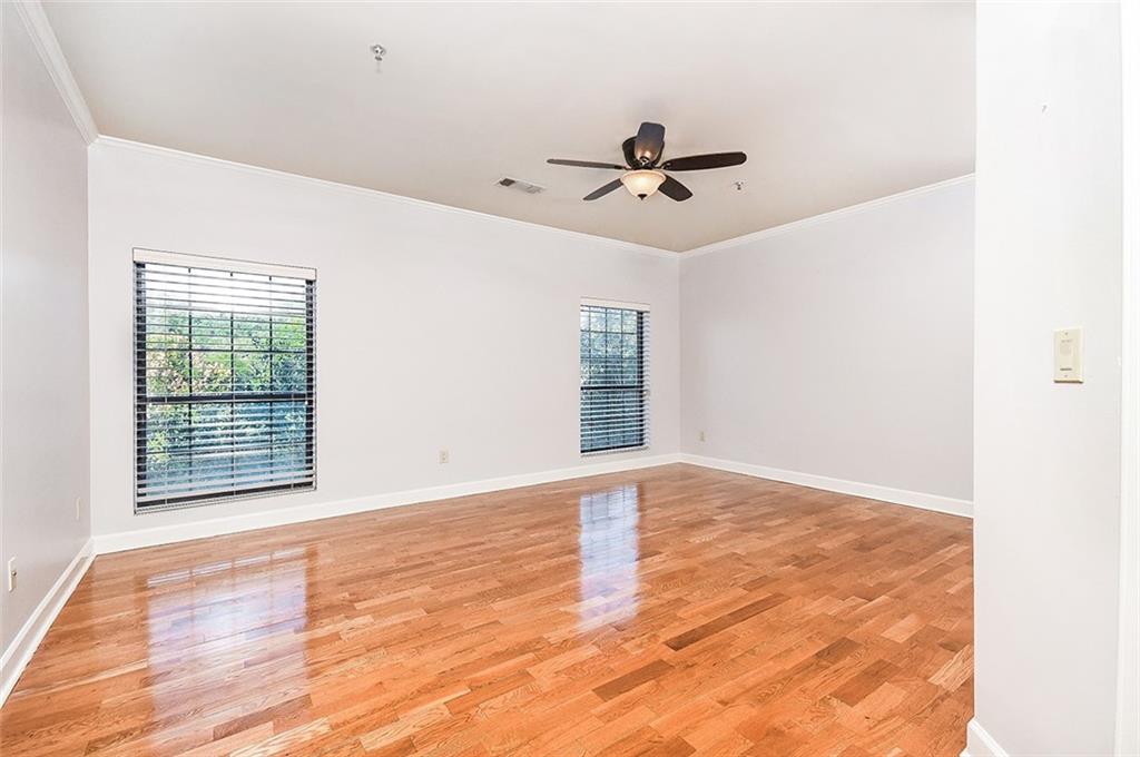 2865 Lenox Road Northeast, Unit 407 Atlanta, GA 30324 - Photo 15 of 27 a view of empty room with wooden floor and fan