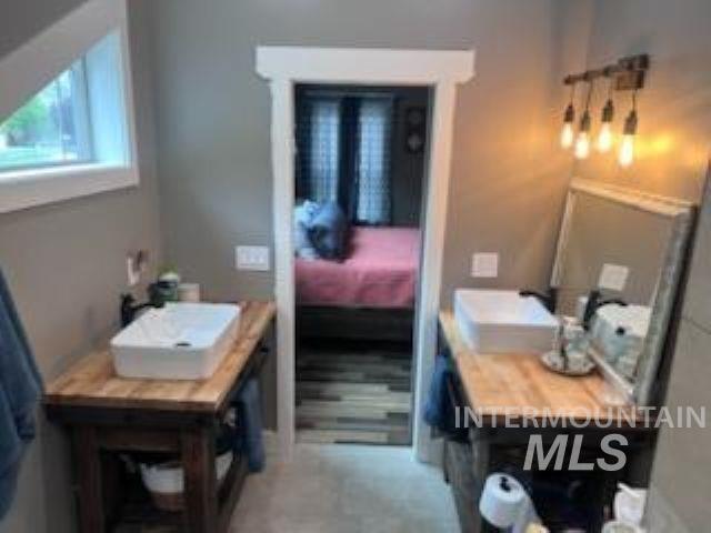 1006 Borah Avenue Riggins, ID 83549 - Photo 24 of 24 Bathroom featuring two wood-finish vanity stations, each with a rectangular vessel sink and wall-mounted faucet
