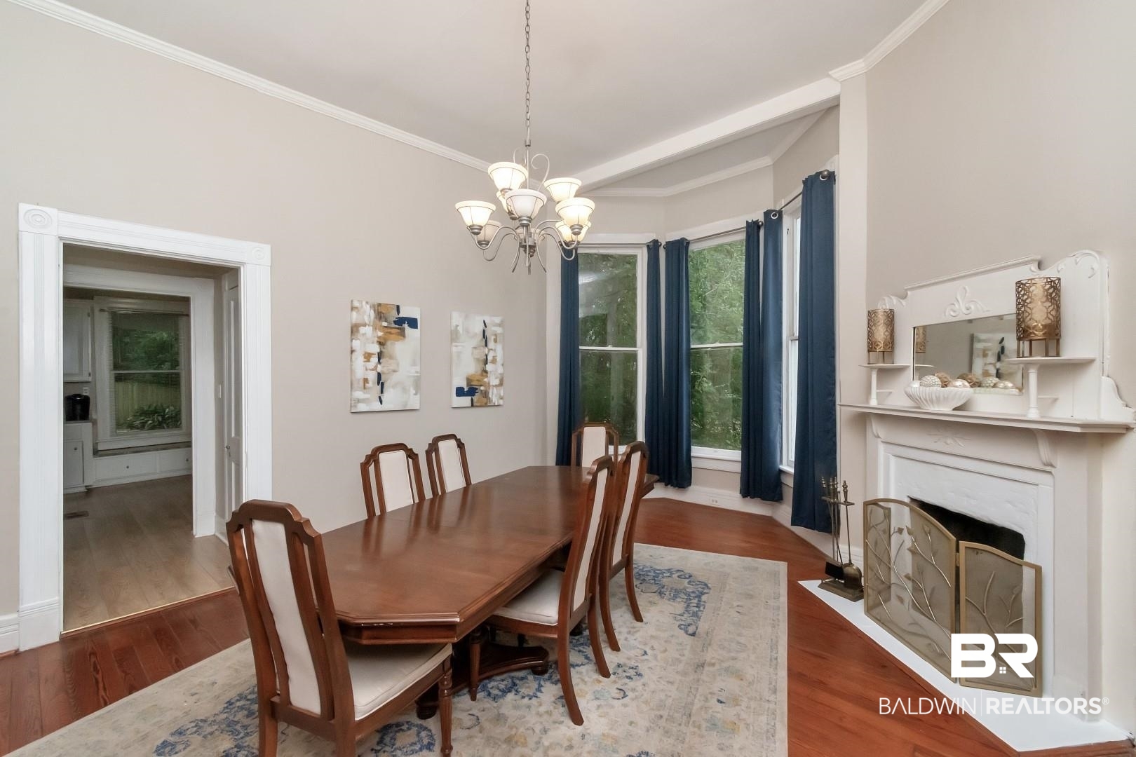 1305 Brown Street Mobile, AL 36604 - Photo 11 of 37 Dining area featuring crown molding, hardwood / wood-style flooring, and an inviting chandelier