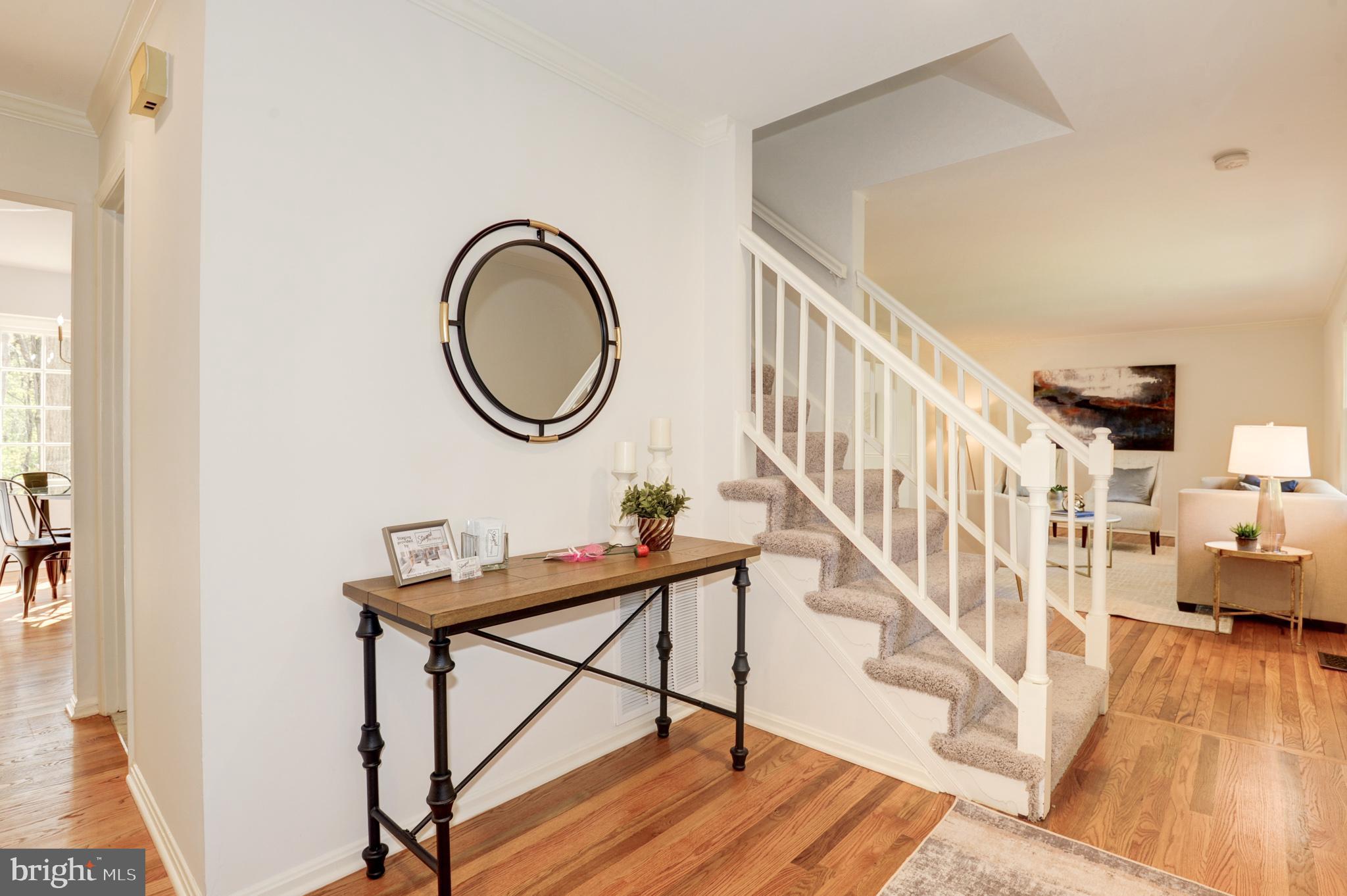 10809 Cross School Road Reston, VA 20191 - Photo 16 of 60 a view of a hallway with wooden floor and staircase