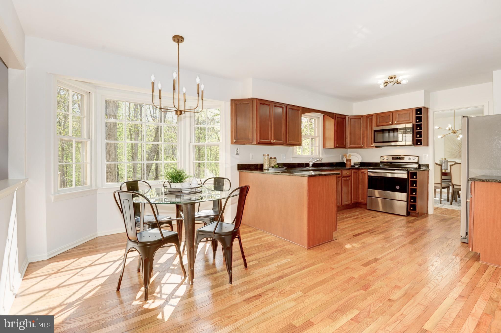 10809 Cross School Road Reston, VA 20191 - Photo 18 of 60 a view of a dining room with furniture window and wooden floor
