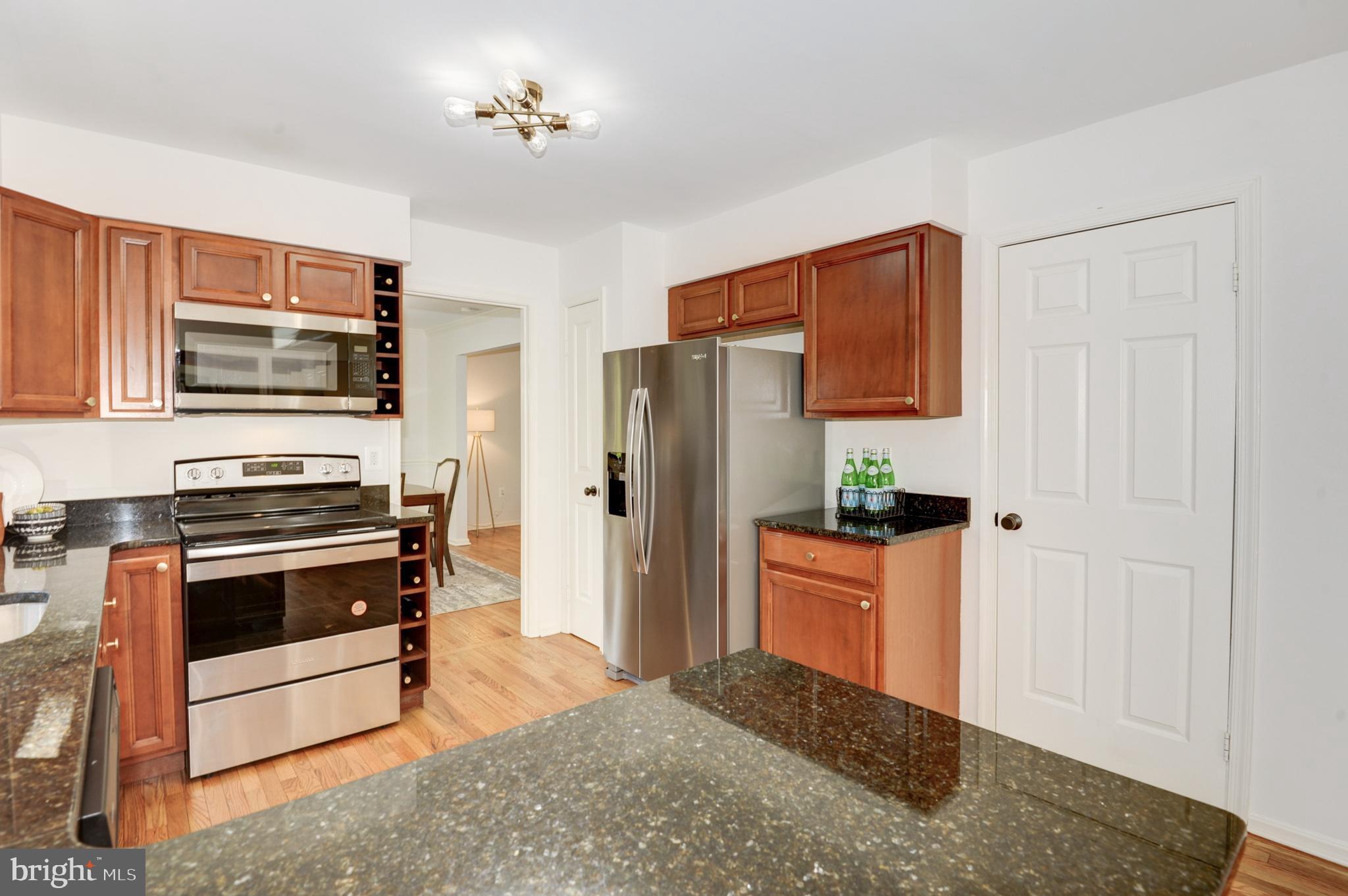 10809 Cross School Road Reston, VA 20191 - Photo 20 of 60 a kitchen with stainless steel appliances a stove microwave and refrigerator
