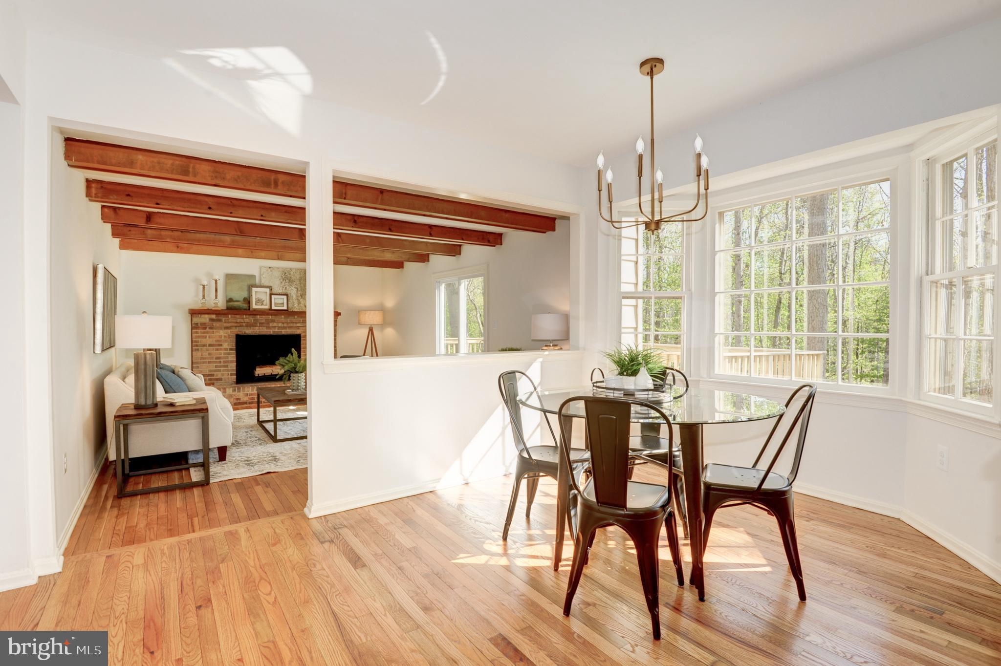 10809 Cross School Road Reston, VA 20191 - Photo 22 of 60 a view of a dining room with furniture window and wooden floor