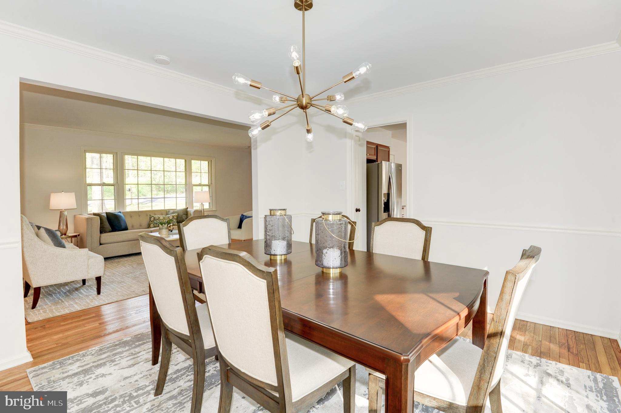 10809 Cross School Road Reston, VA 20191 - Photo 30 of 60 a dining room with furniture a chandelier and wooden floor